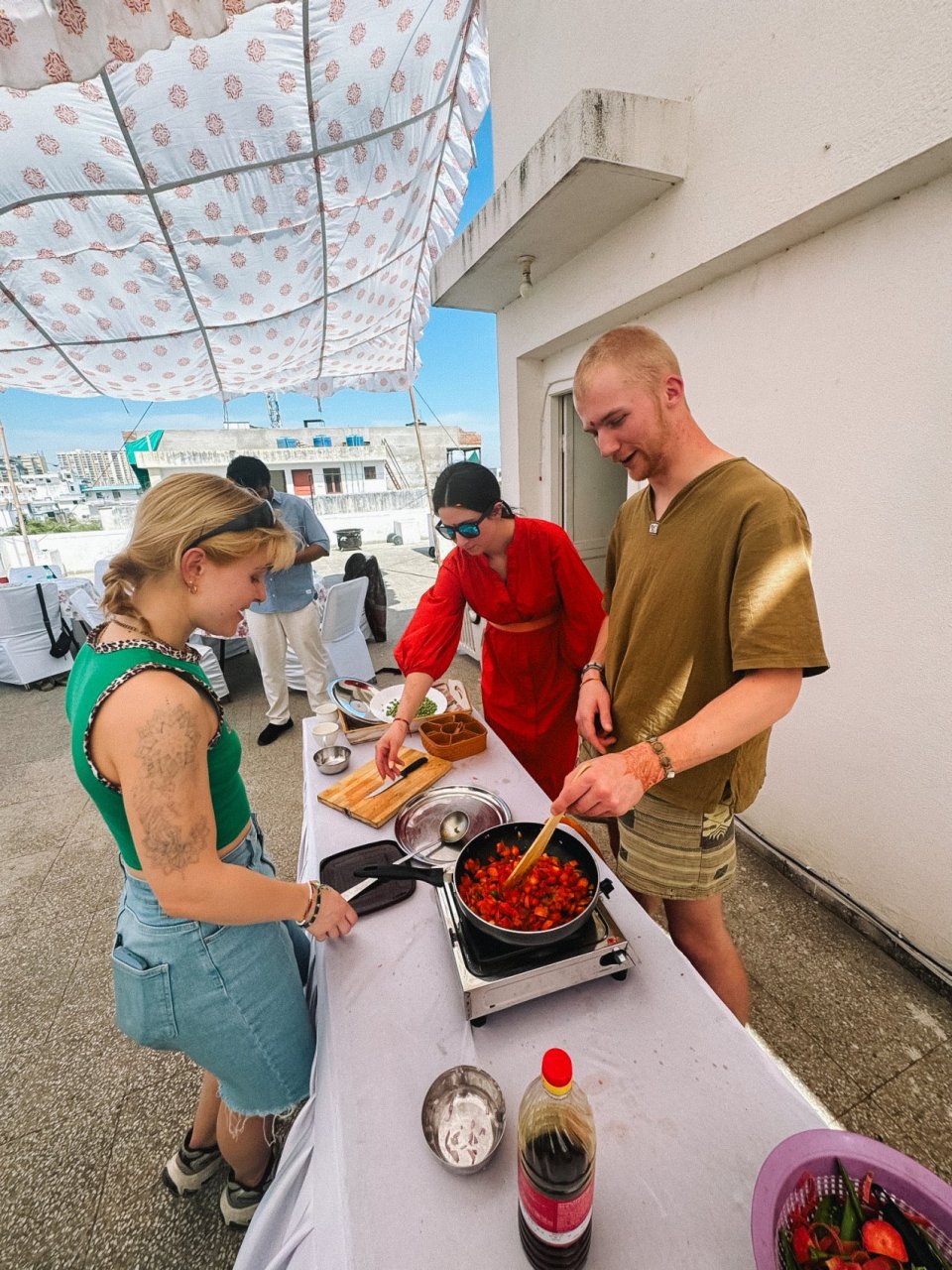Group of solo travellers on a group tour with TruTravels enjoying a traditional cooking class in Jaipur